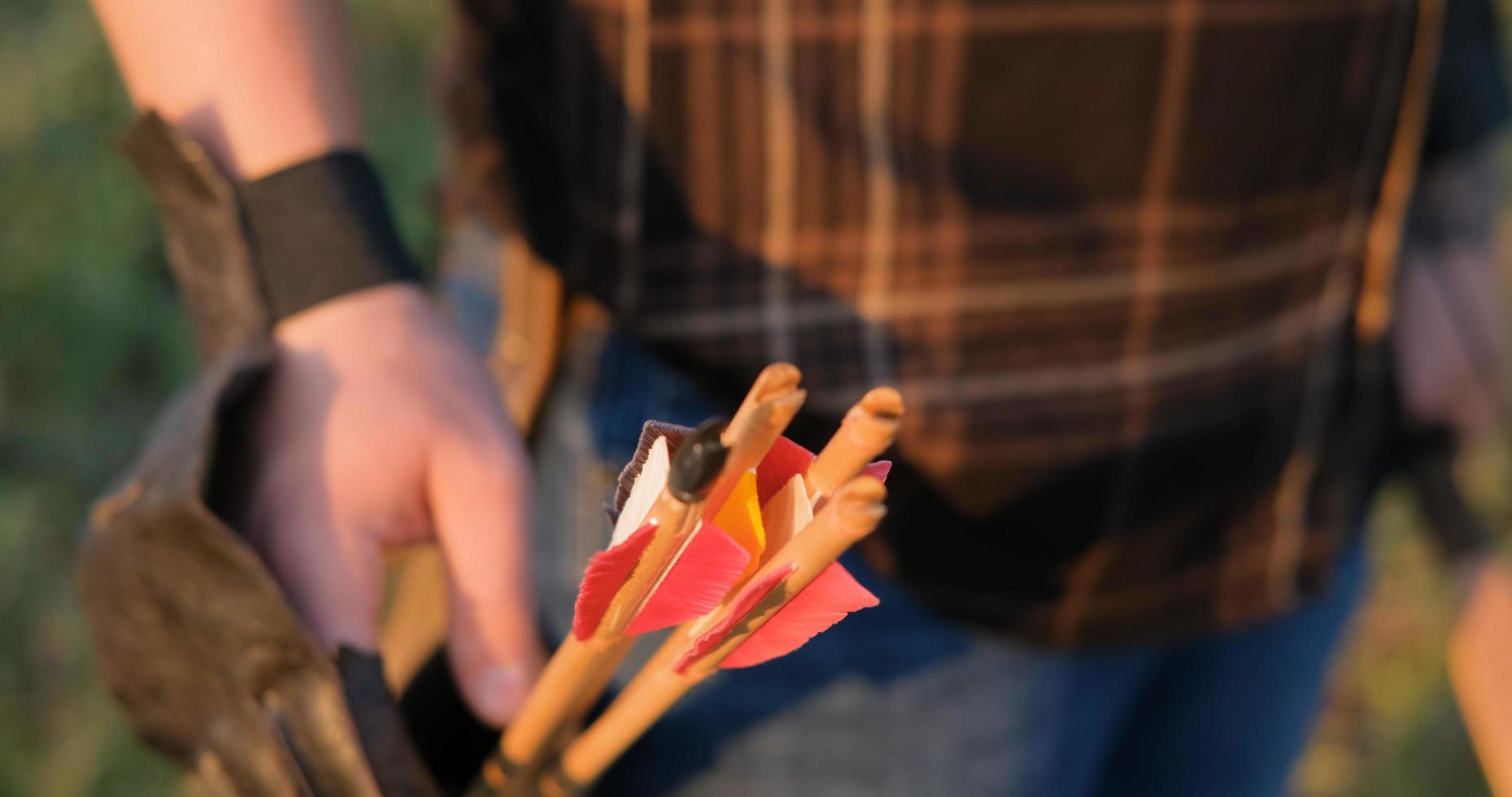 Man with bow outdoors in the field photo