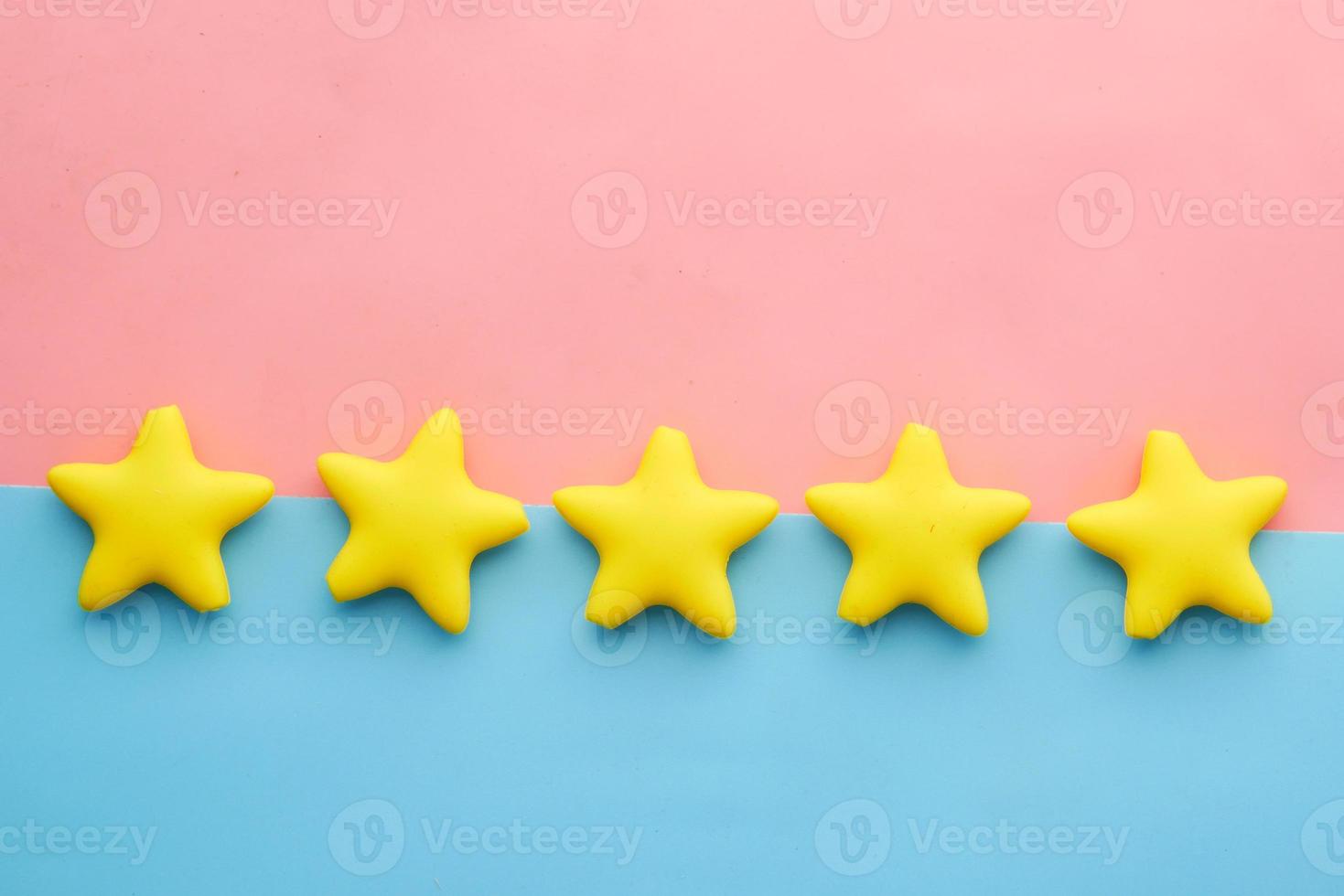 Customer review concept. Rating golden stars on blue background photo