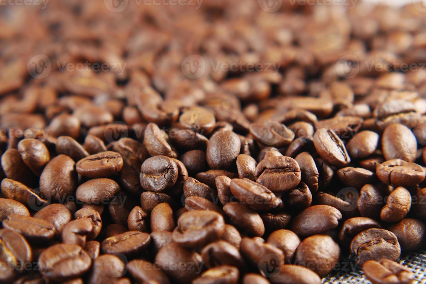 top view of fresh coffee beans on black background with copy space. photo