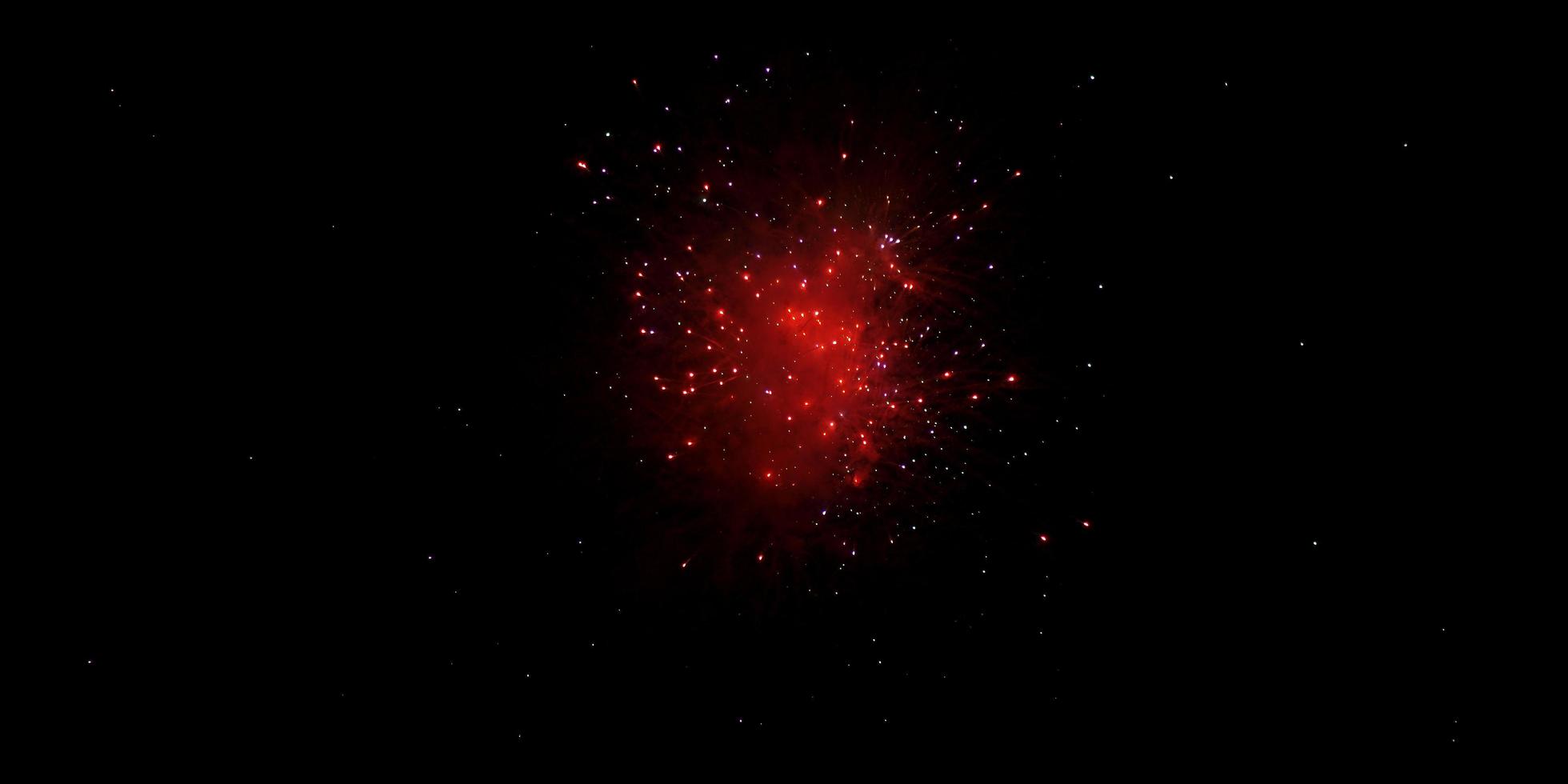 Red fireworks over black sky photo
