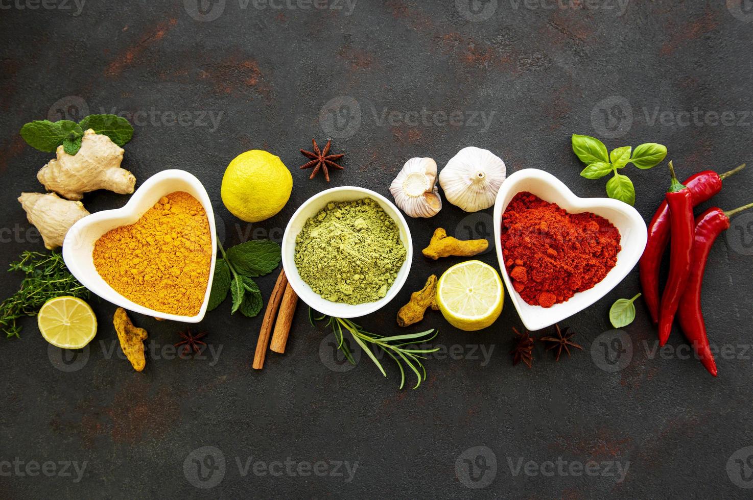 Various spices in a bowls on a black photo