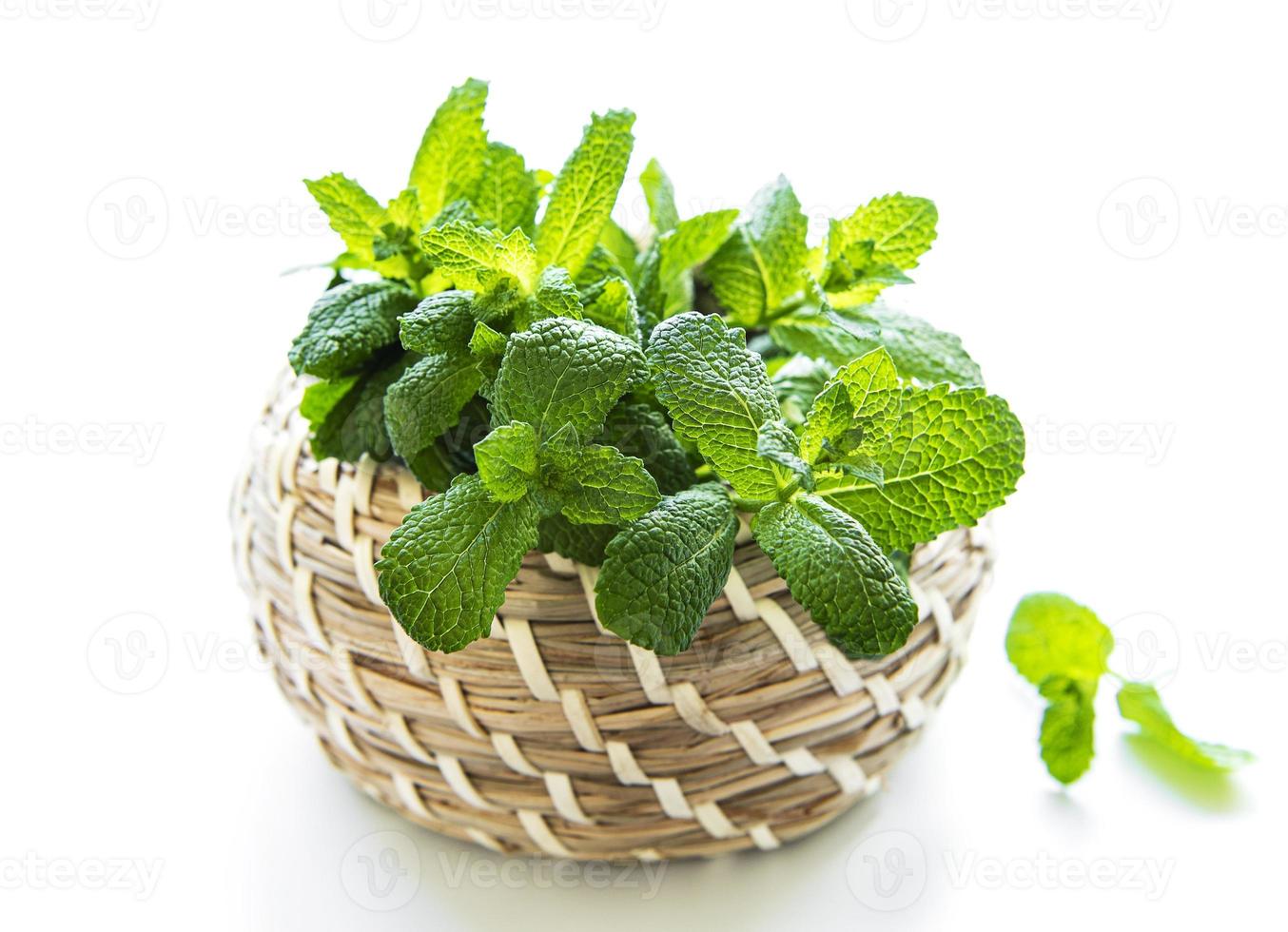 Basket of fresh mint. Isolated on white background photo