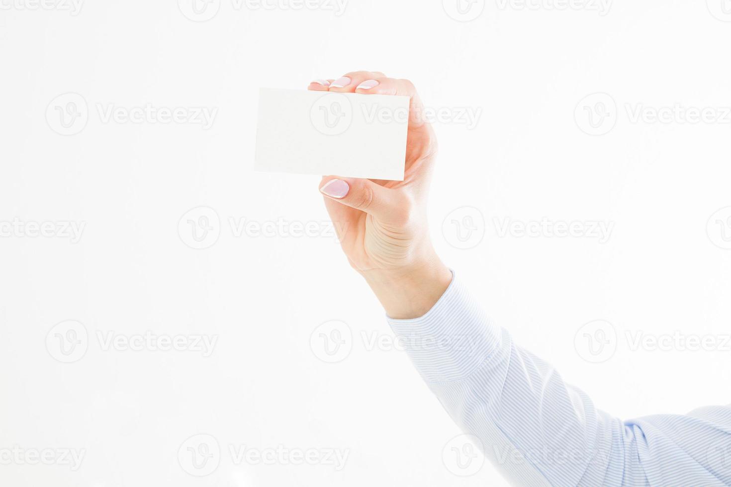 female hand holding business card isolated on white background. Copy space photo