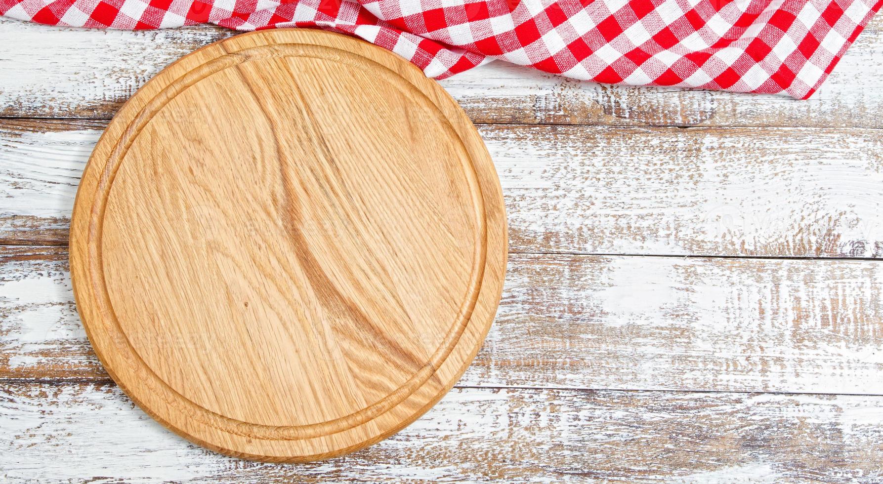 Napkin and board for pizza on wooden desk closeup, tablecloth. Canvas, dish towels on white wooden table background top view mock up. Selective focus photo