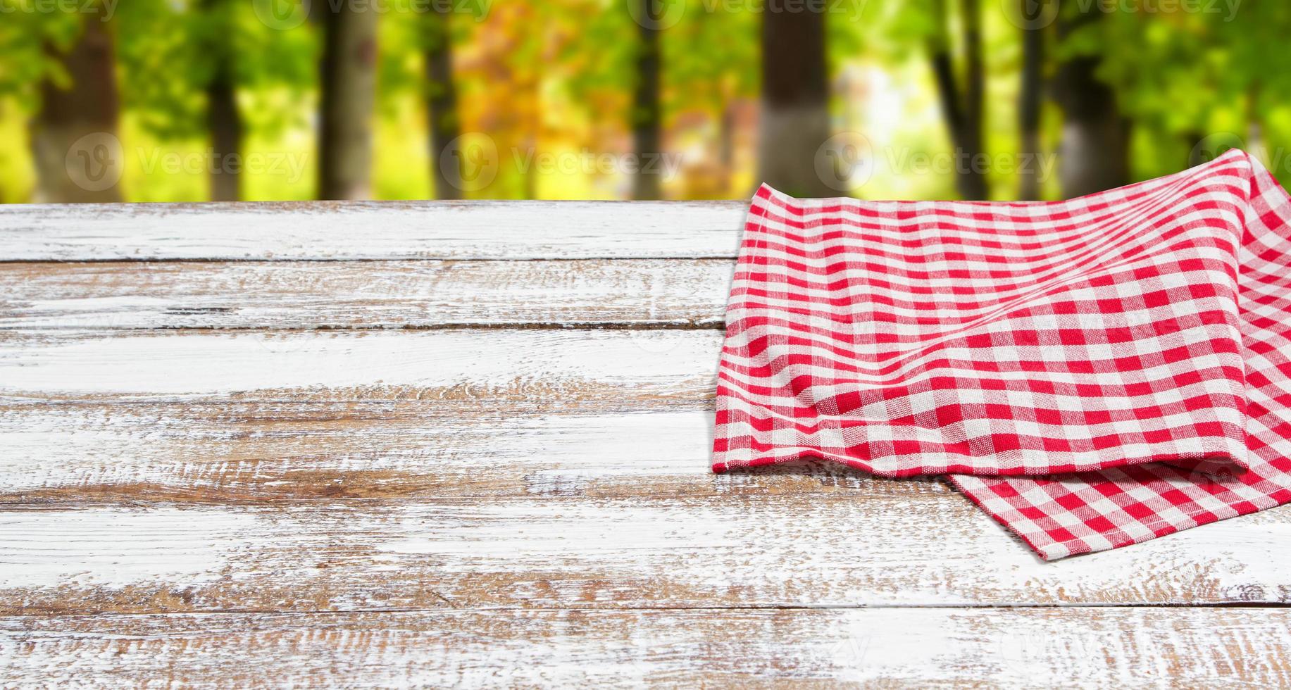 checkered red tablecloth on an empty table - top view photo