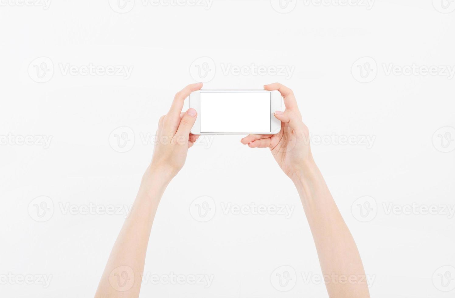 Hand holding white phone isolated on white clipping path inside. Top view.Mock up.Copy space.Template.Blank. photo