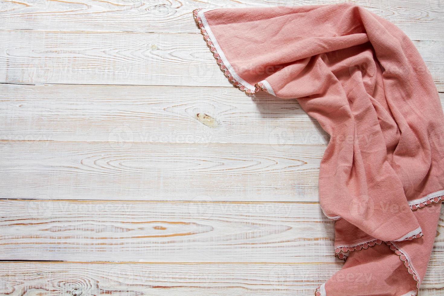 Kitchen table with folded towel. Top view with copy space photo