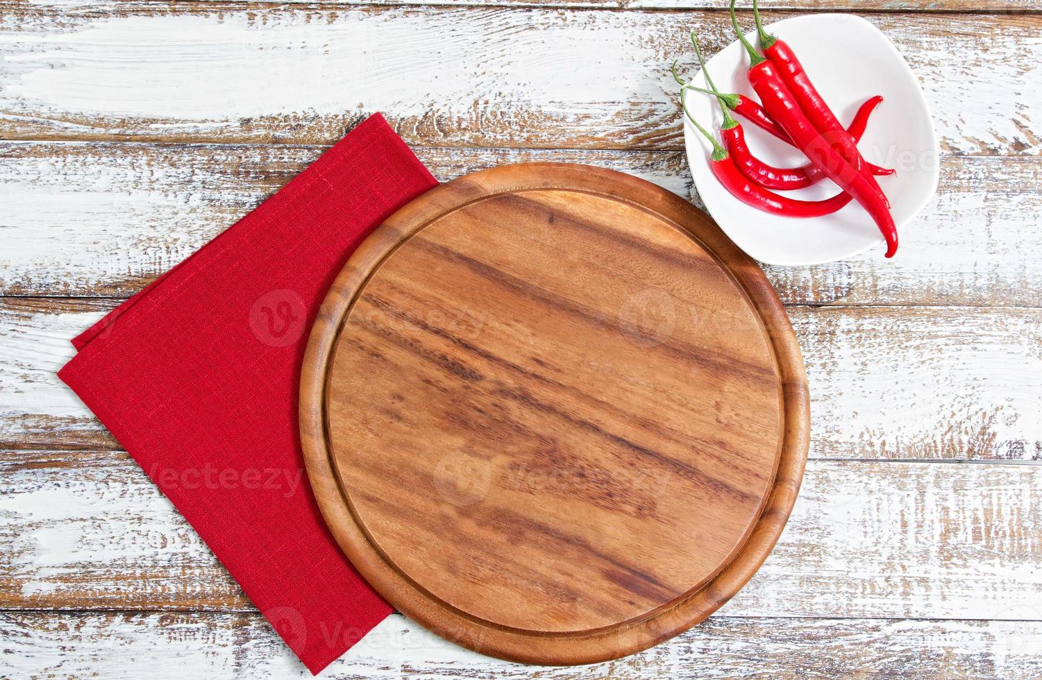 empty board and red hot pepper on an empty table photo