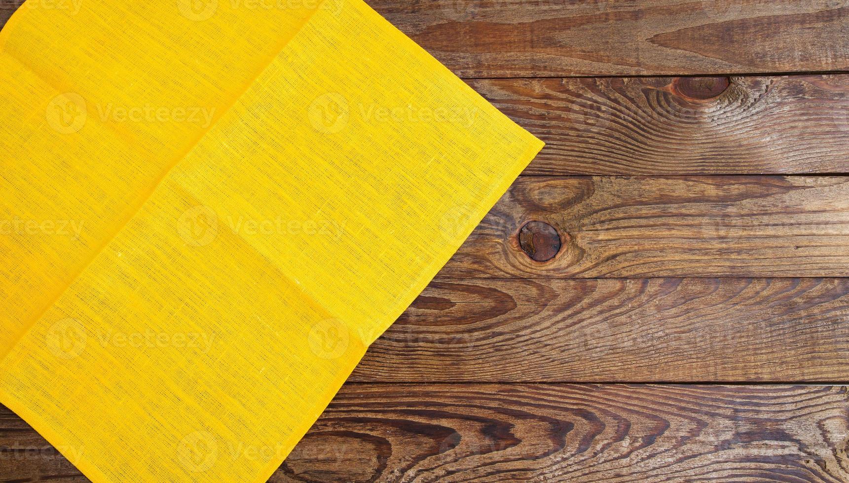 coloured napkins on empty wooden table - top view, copy space photo