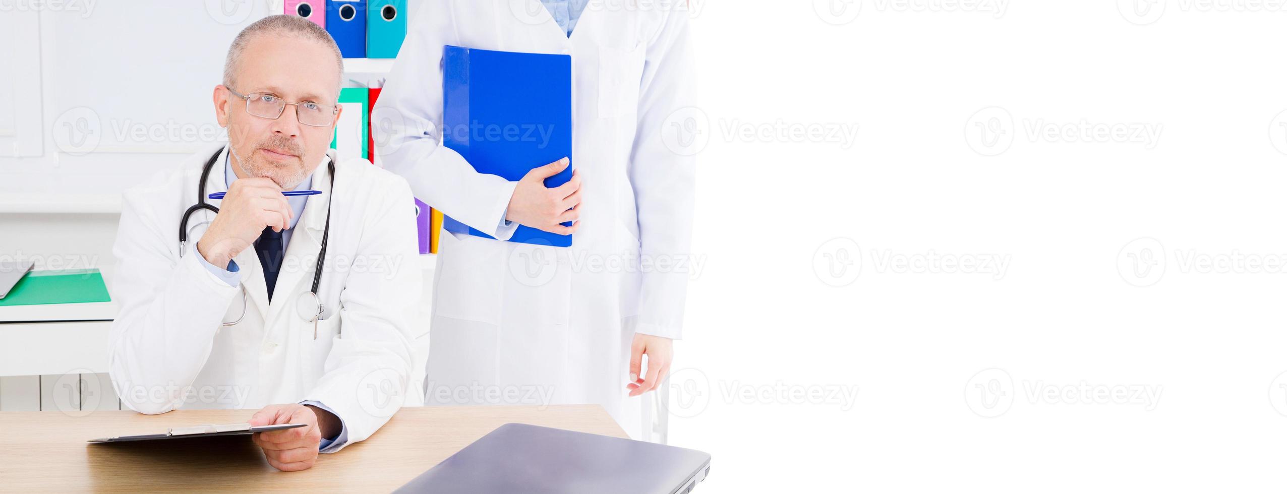 doctor with nurse sitting in the office of the clinic, medical insurance,copy space,billboard or banner photo