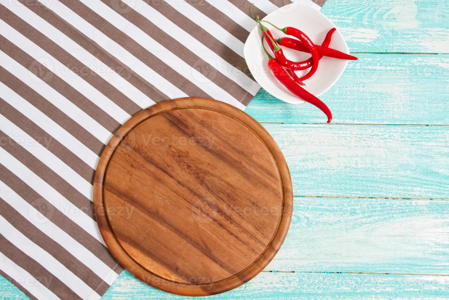 Napkin and board for pizza on wooden desk closeup, tablecloth. Canvas, dish towels on white wooden table background top view mock up. Selective focus photo