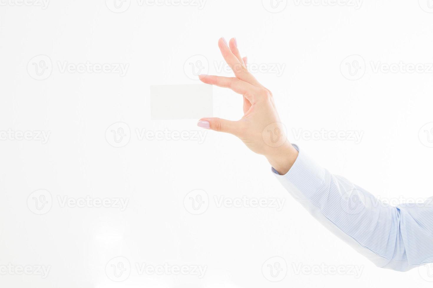 female hand holding business card isolated on white background. Copy space photo