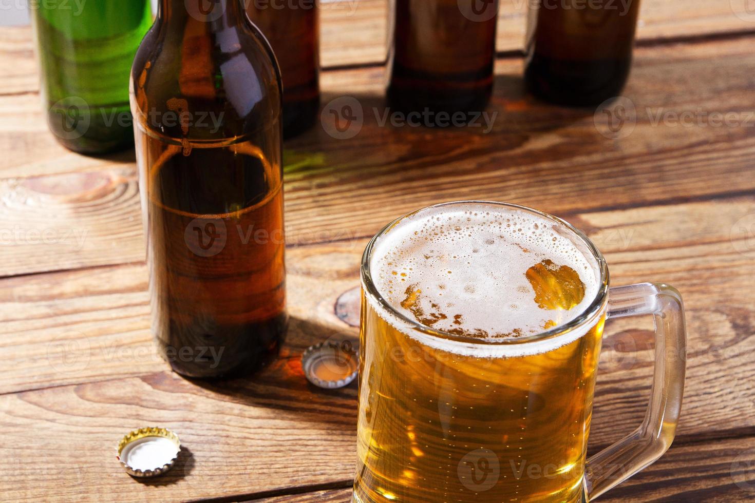 glass of beer on wooden table, top view. Beer bottles. Selective focus. Mock up. Copy space.Template. Blank. photo