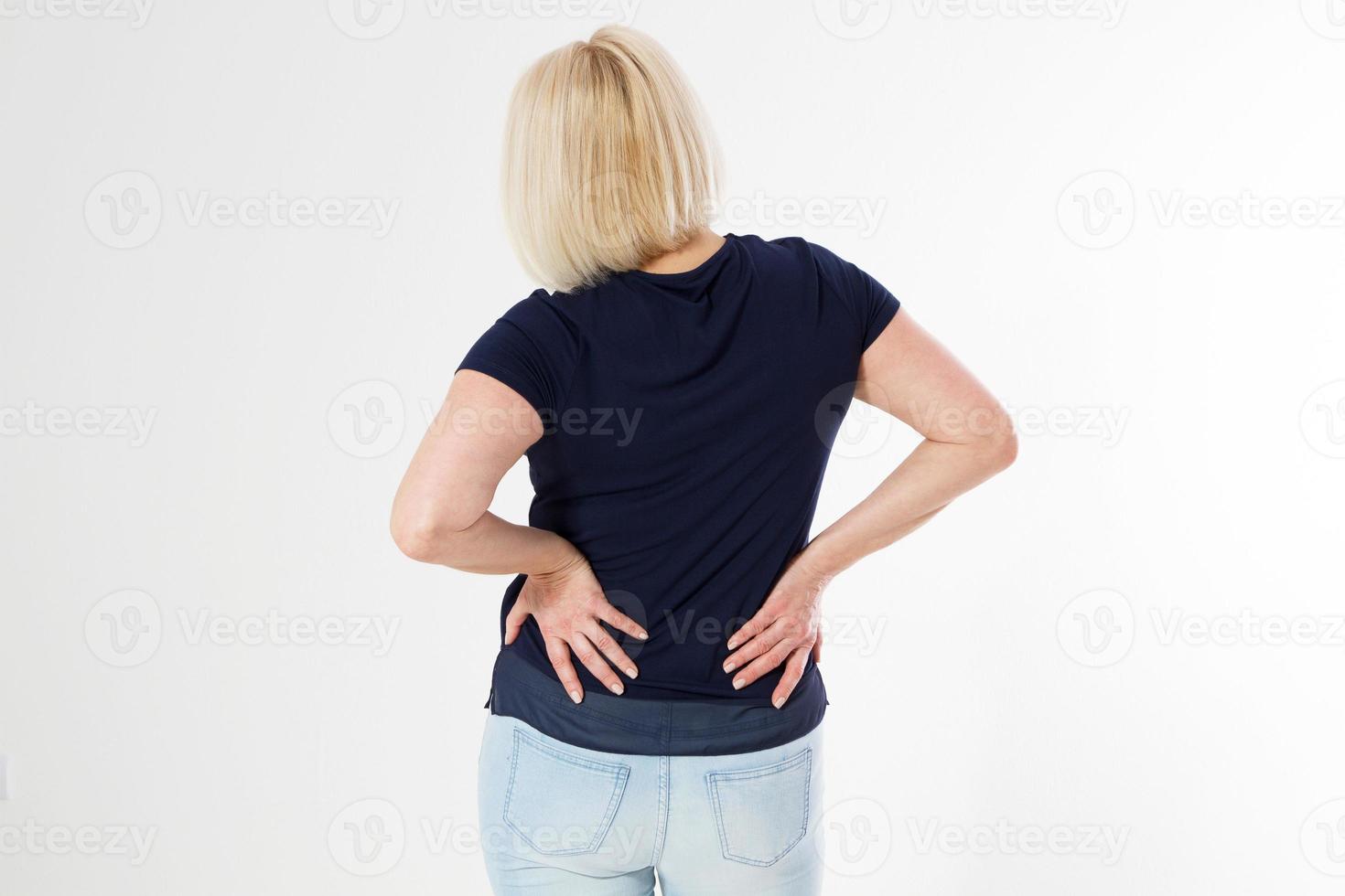 Woman female back ache, back pain, Female body showing pain in back spine.Medical concept,Middle age Woman standing in white and touching her back copy space photo