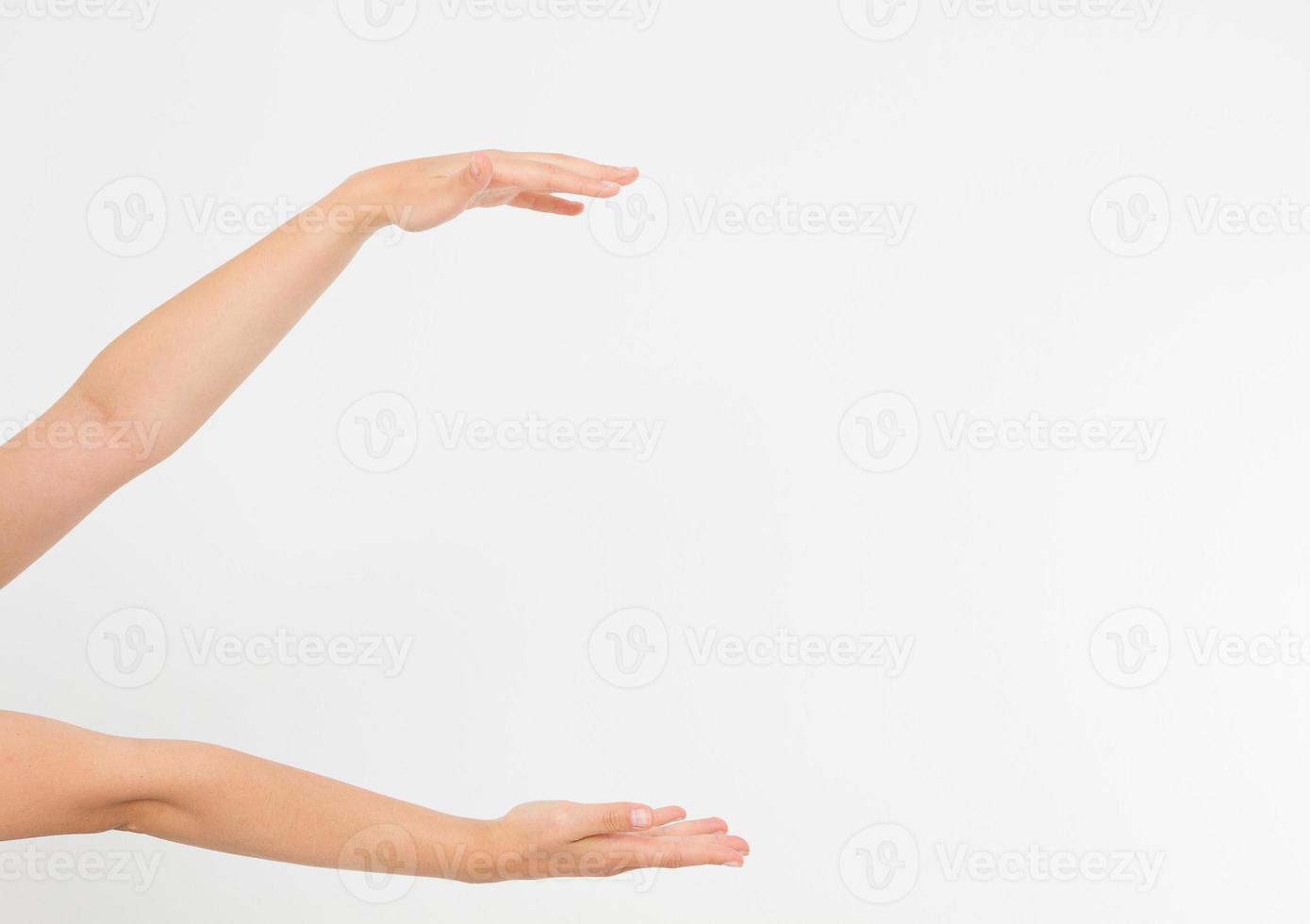 female hands measuring invisible items, woman's palm making gesture while showing small amount of something on white isolated background, side view, close-up, cutout, copy space photo