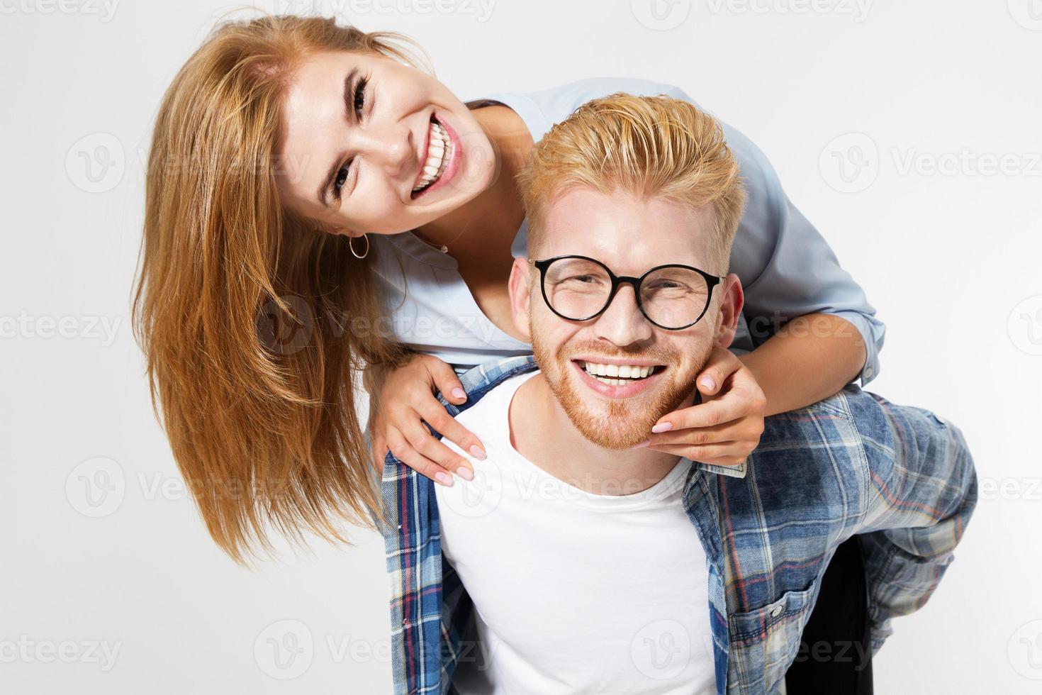 Portrait of a beautiful young happy smiling elegant couple - isolated mock up, background people.B eautiful young happy couple love smiling embracing, man and woman smile looking at camera photo