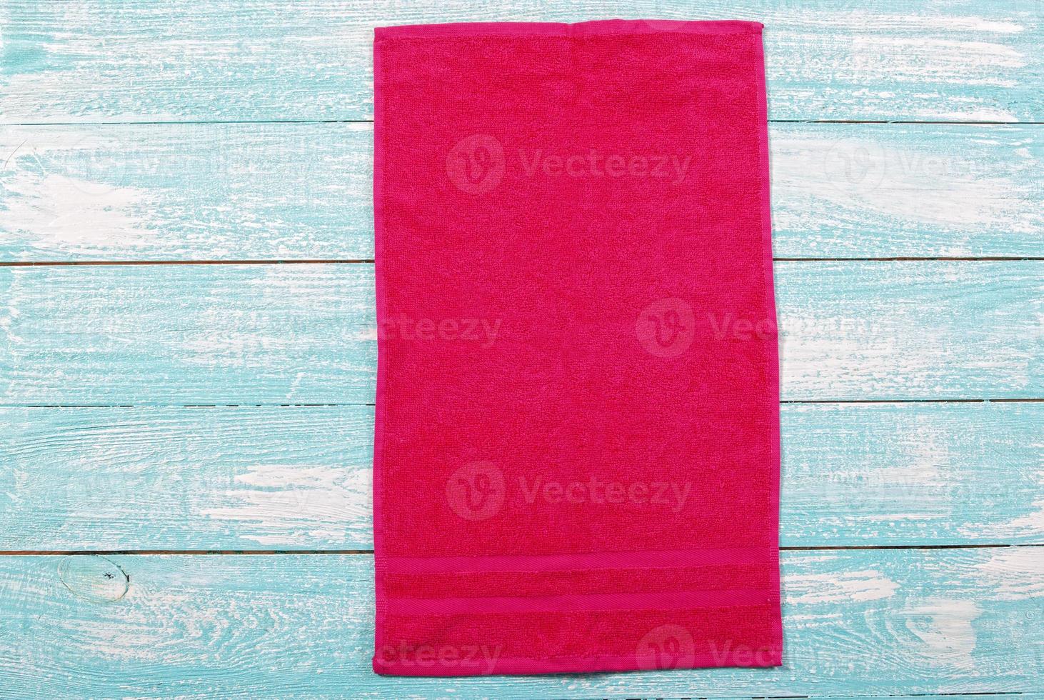 Red soft towel on wooden background mockup copy space photo