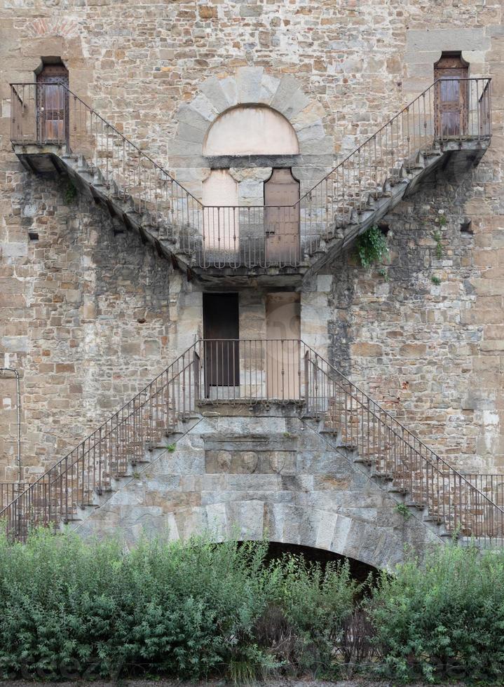 Exterior detail of antique building in Florence, Italy, with Escher architecture style. photo