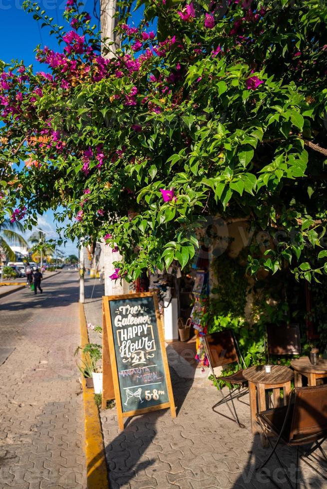 Empty chairs and tables at open air restaurant with signboard photo
