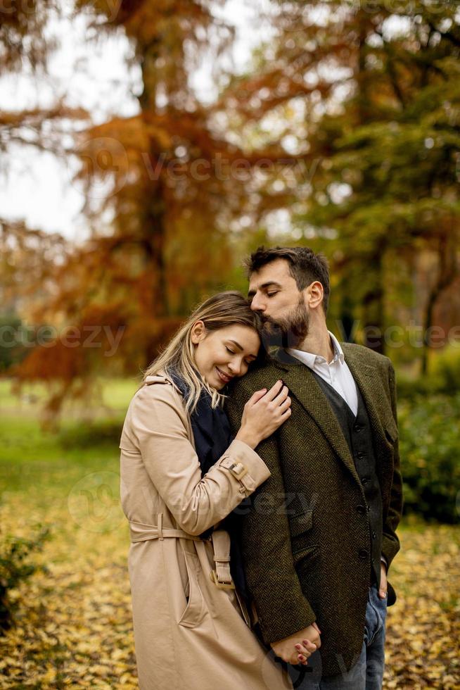 Young couple in the autumn park photo