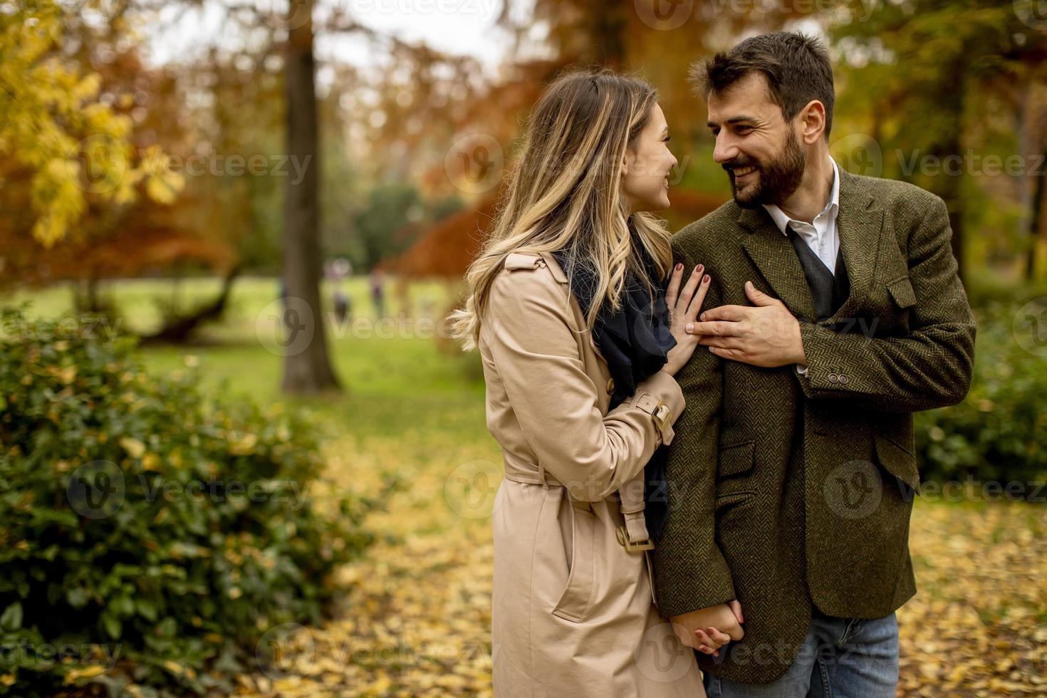 Young couple walking in the autumn park photo