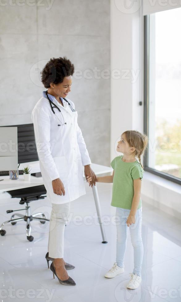 Cute little girl at the pediatrician examination photo