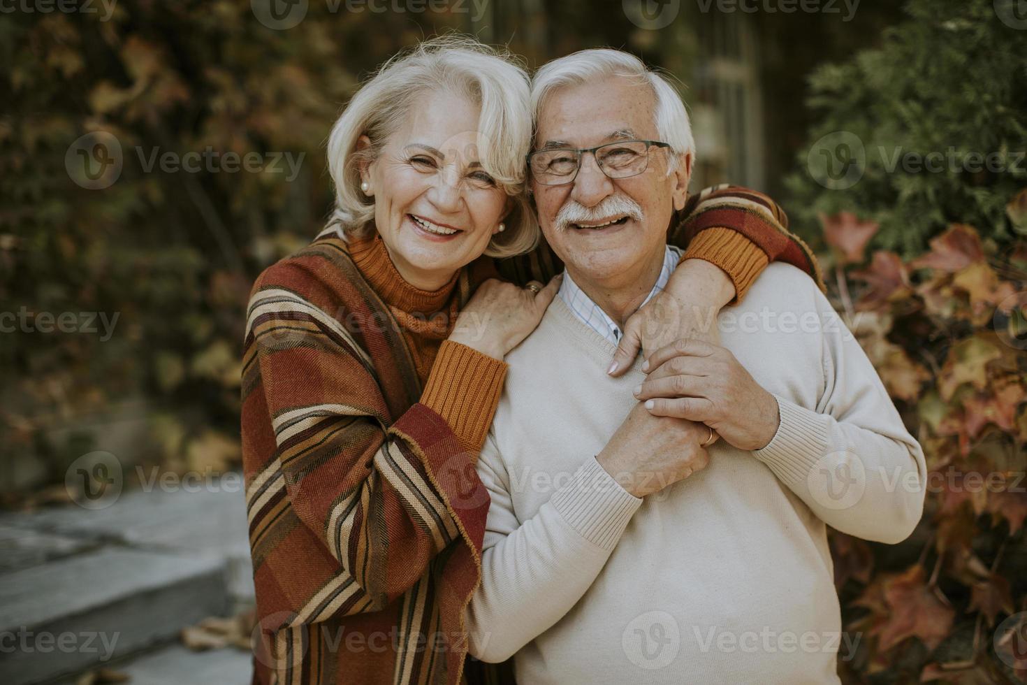 Senior couple embracing in autumn park photo