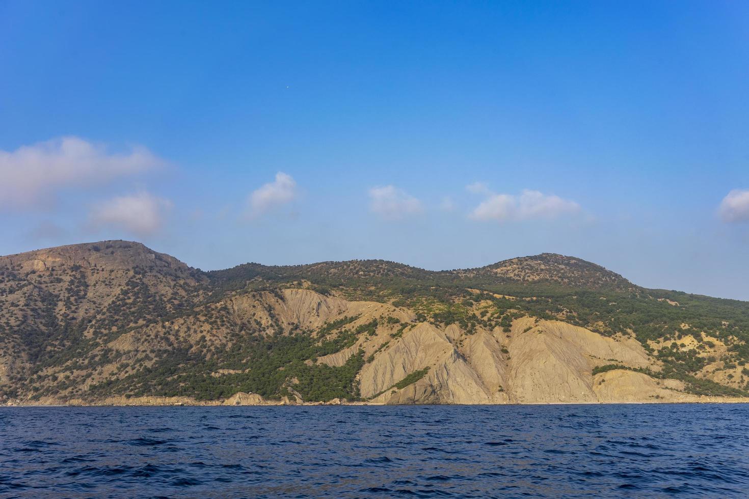 Seascape with a view of the hilly coastline photo