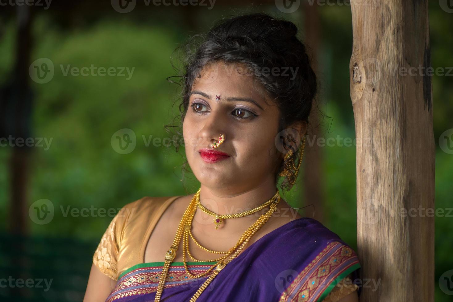 Beautiful Indian young girl in Traditional Saree posing outdoors photo