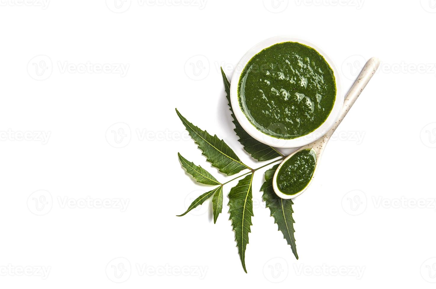 Medicinal Neem leaves with neem paste in spoon and plate on white background Azadirachta indica photo