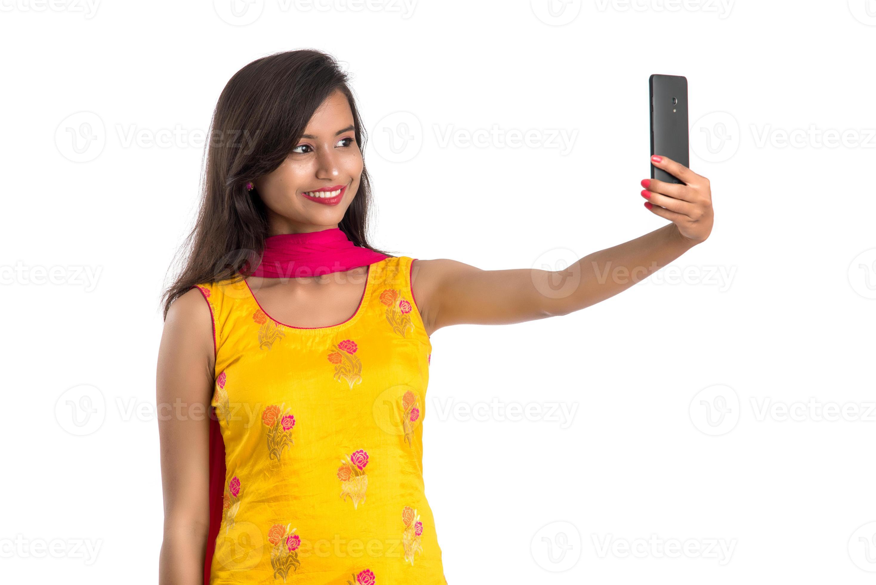 Young Indian girl using a Tablet, mobile phone or smartphone isolated on a  white background 5045201 Stock Photo at Vecteezy
