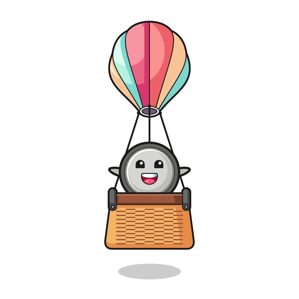 mascota de celda de botón montando un globo de aire caliente vector