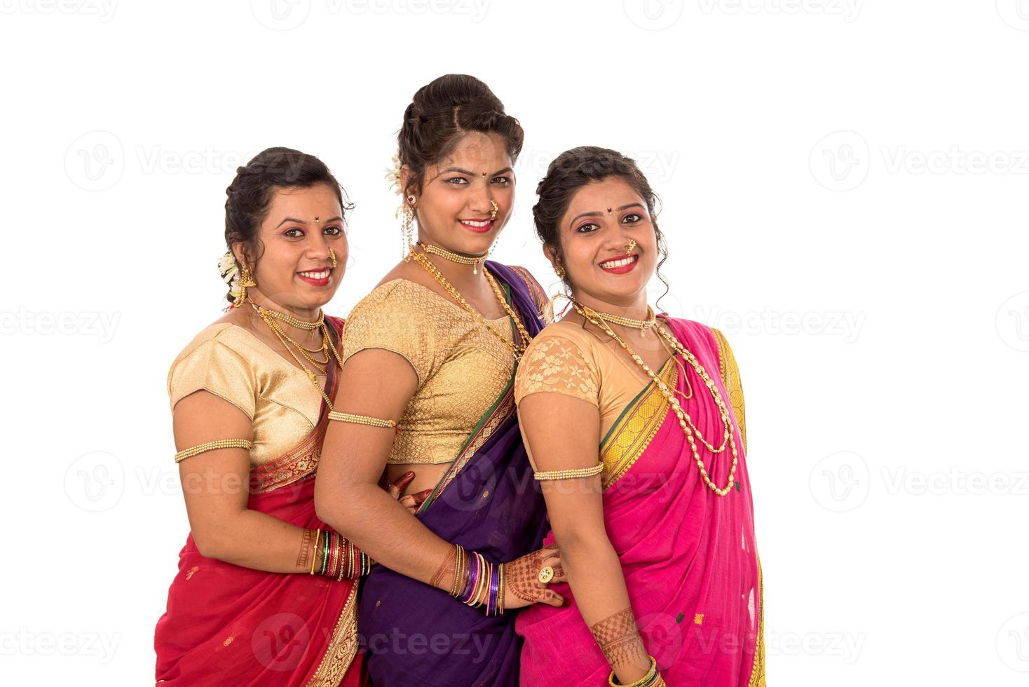 Traditional Beautiful Indian young girls in saree posing on white background photo