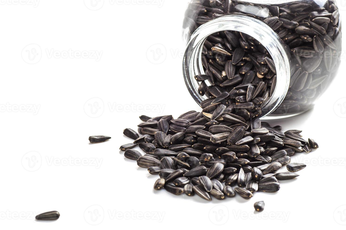 Sunflower Seeds in glass pot on white background. Helianthus annuus. photo