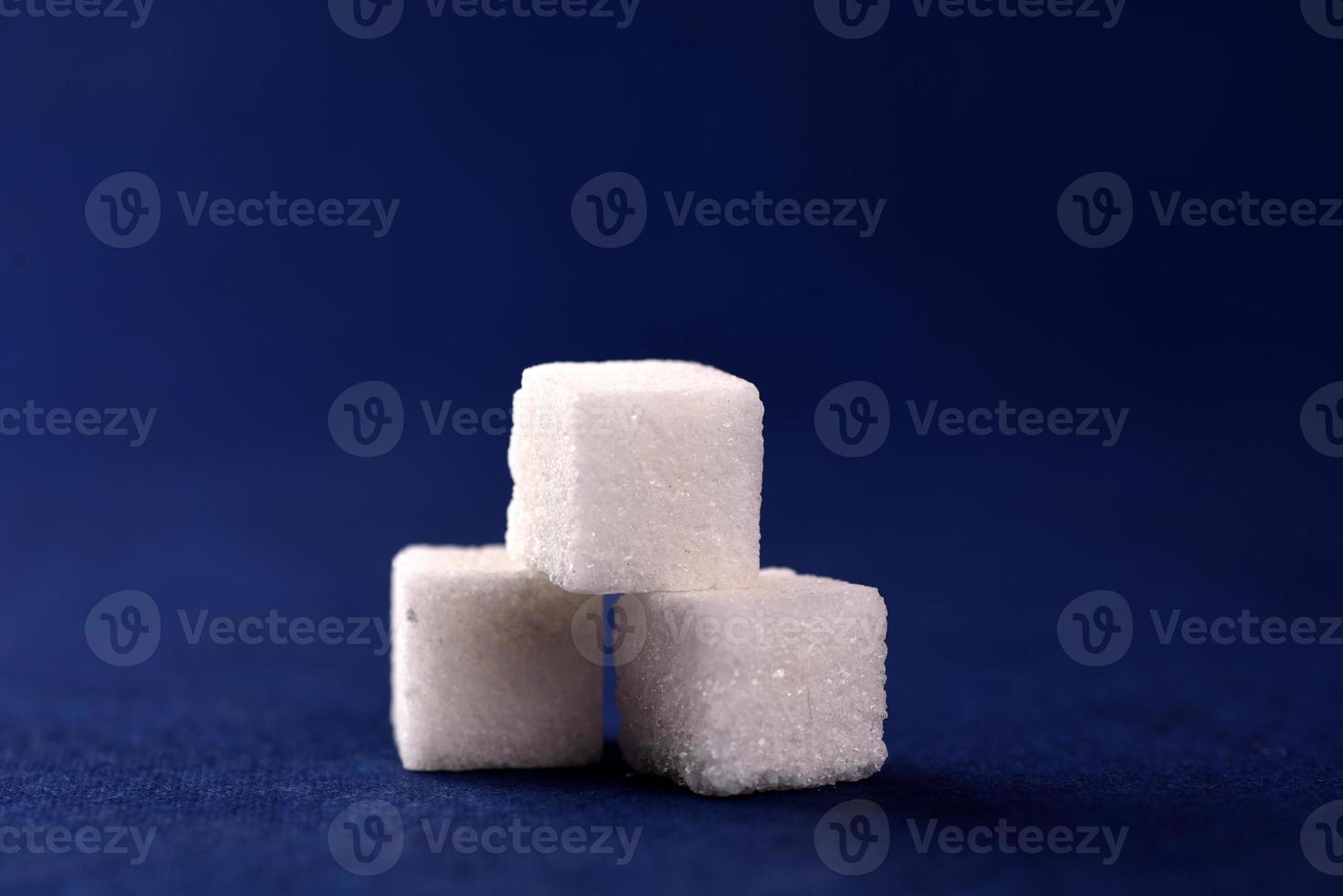 Close-up of Sugar Cubes on Blue Background photo