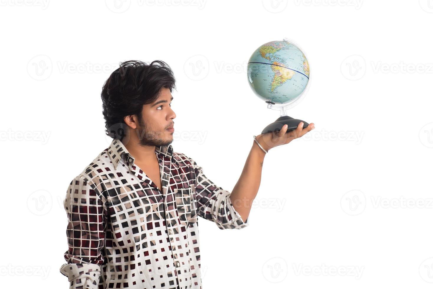 young man with a world globe on a white background. photo