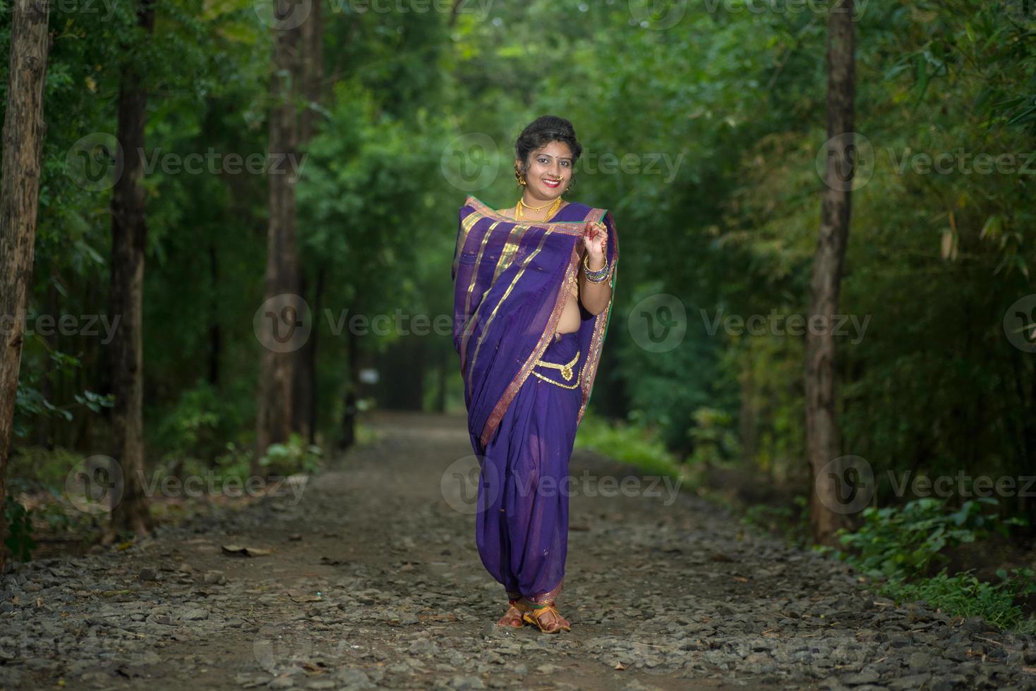 India hermosa joven tradicional en sari posando al aire libre foto