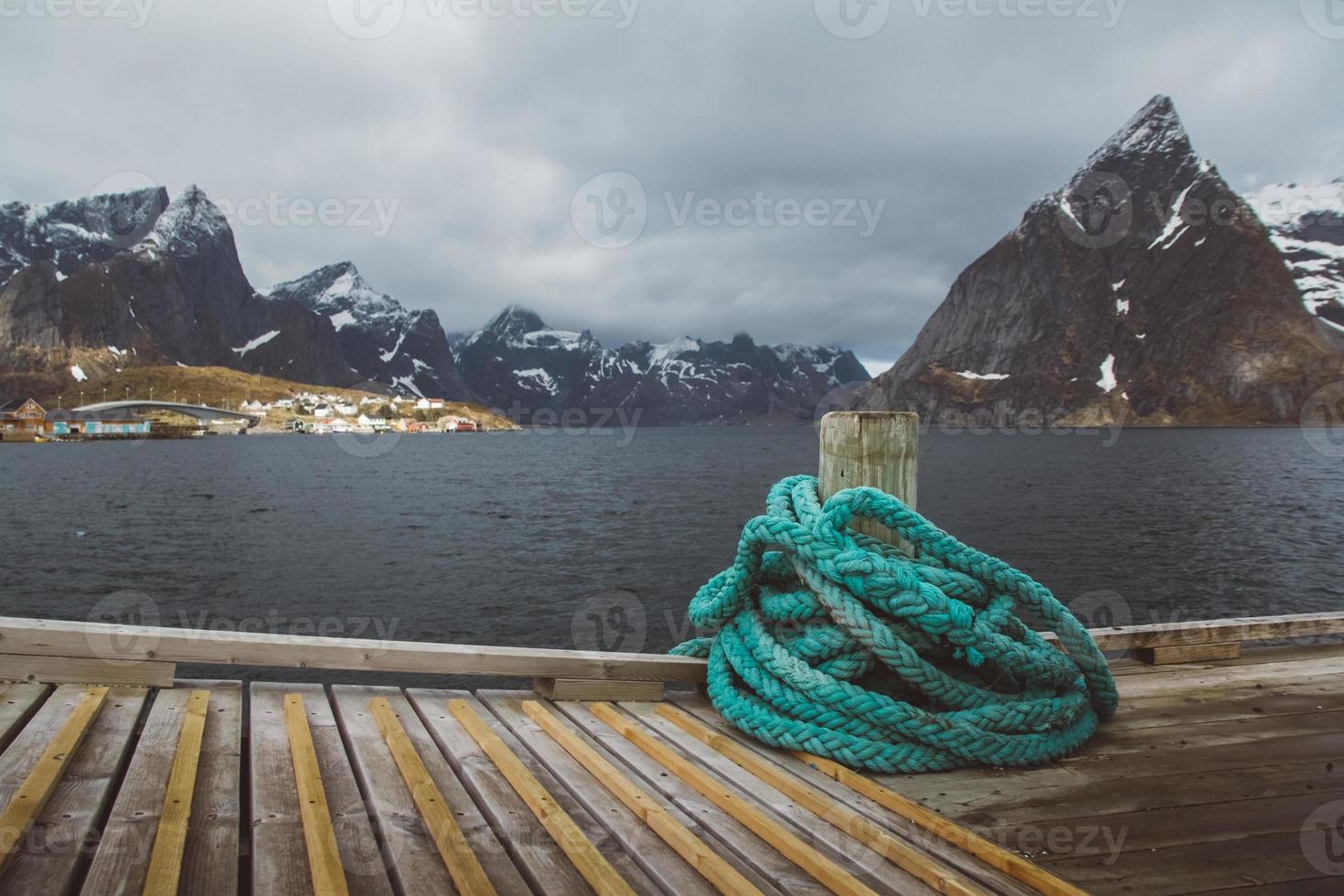 Spriral natical rope at a wooden pier on the background of mountains and landscapes on the islands Lofoten. Place for text or advertising photo