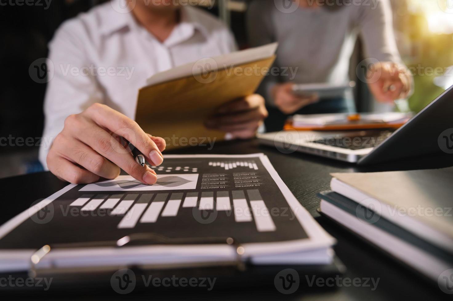 two colleagues discussing data working in the office photo