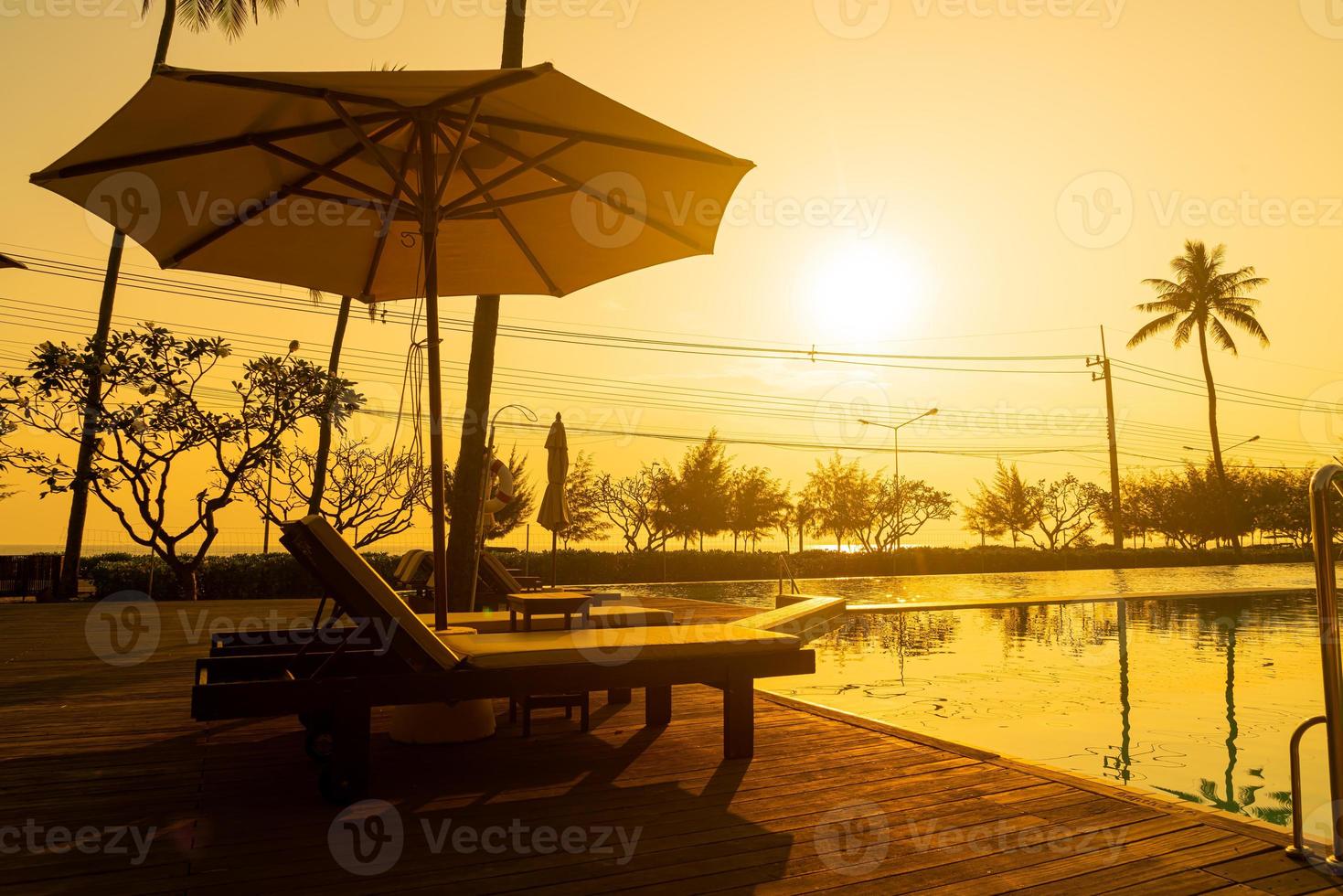 umbrella with bed pool around swimming pool with ocean sea background