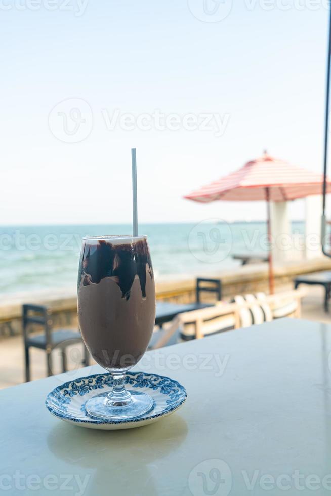 ice chocolate milkshake with sea background photo