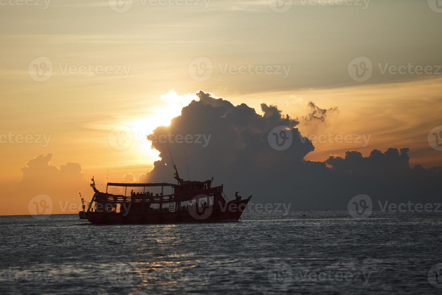 tourist boat cruising against beautiful sunset sky photo