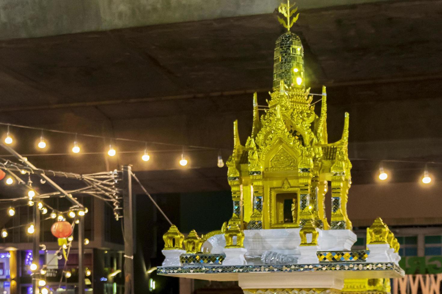 Golden yellow holy shrine at Thai night market Bangkok Thailand. photo