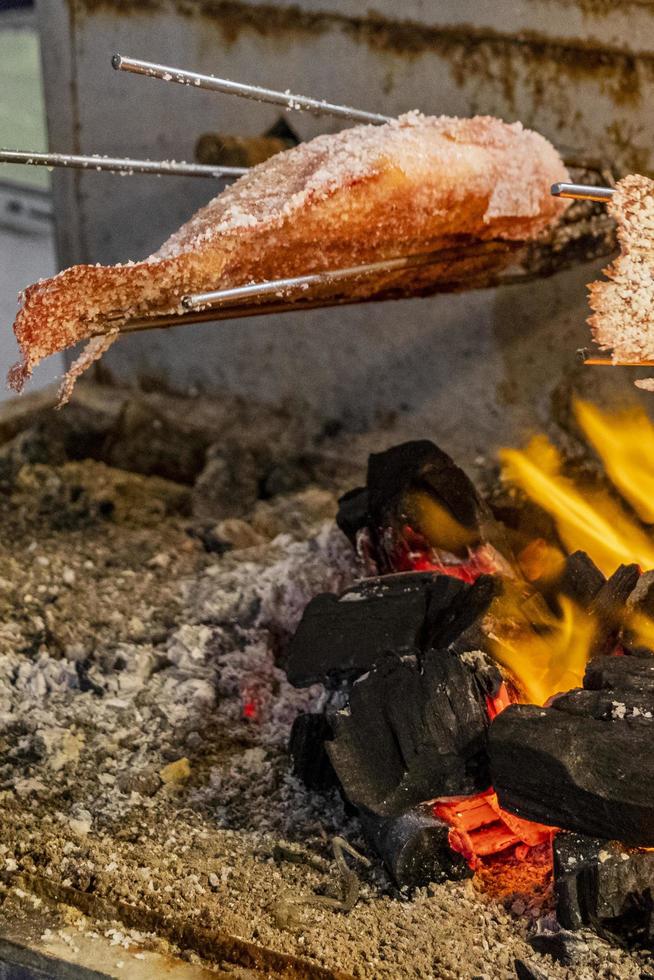 Fish on grill Thai night market street food Bangkok Thailand. photo