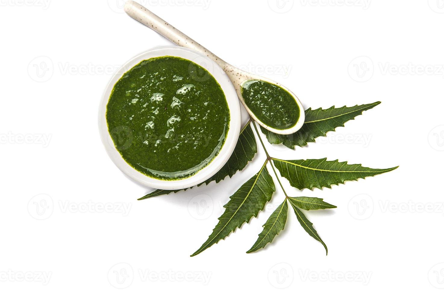 Medicinal Neem leaves with neem paste in spoon and plate on white background Azadirachta indica photo