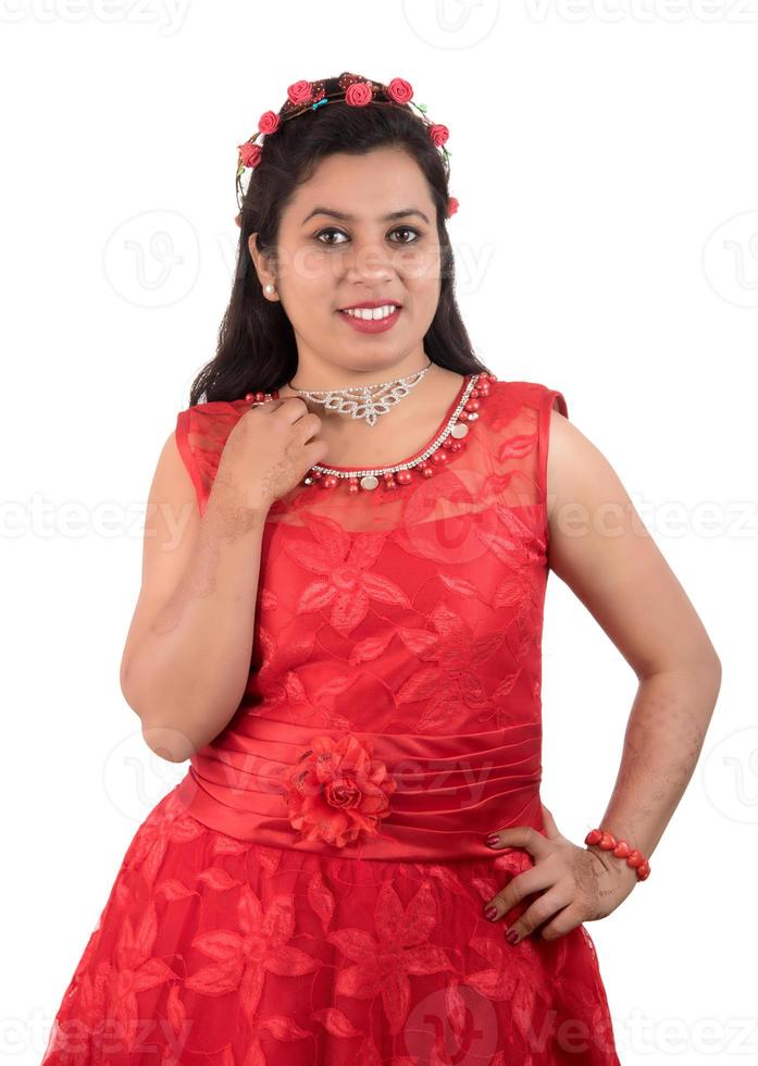 Young girl in red dress posing on white background photo