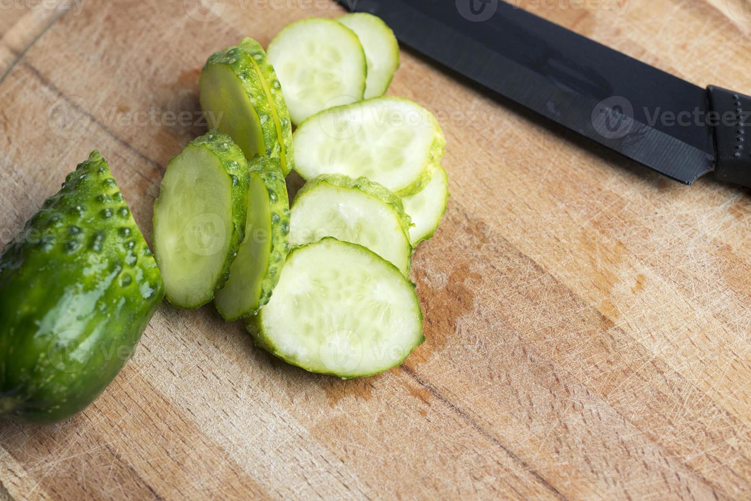 Green cucumber on a cutting Board. photo