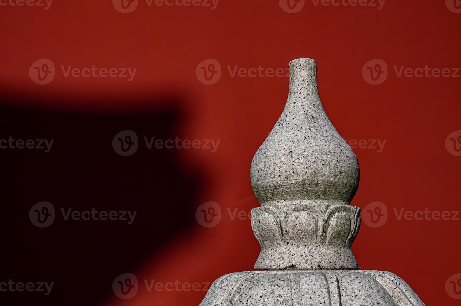 In a temple in fine weather, the sun cast some shadows on the red walls photo