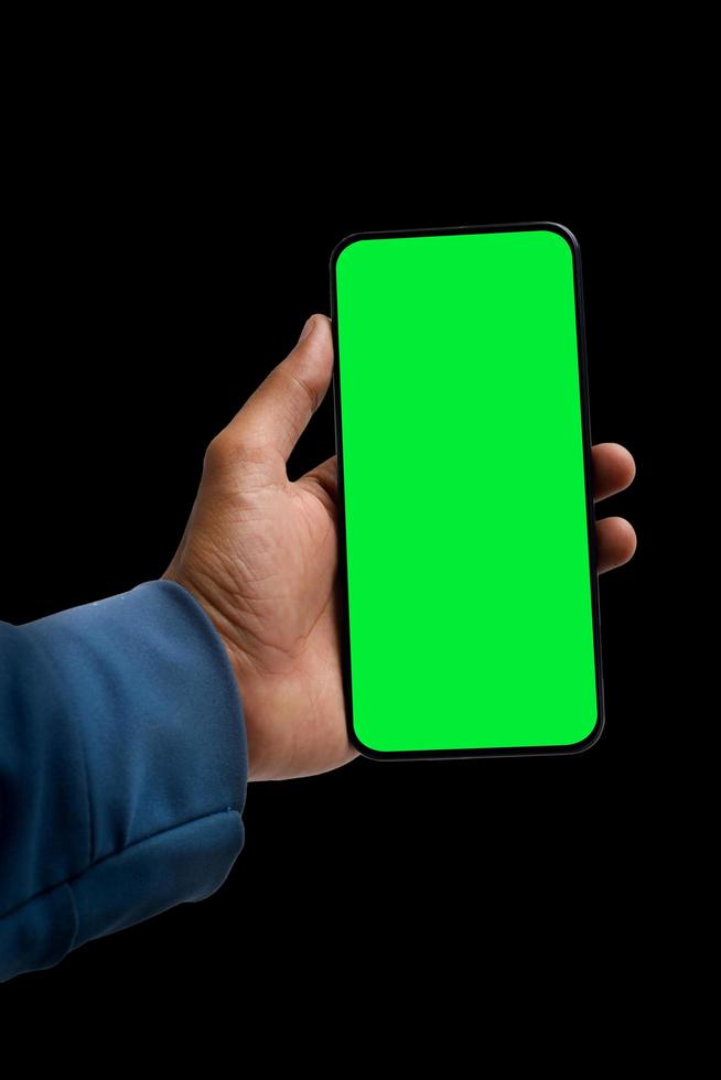 holding smartphone in hand on dark background photo