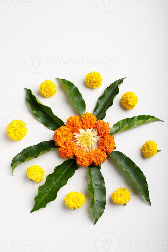 Marigold Flower rangoli Design with green leaf for traditional Festival. photo